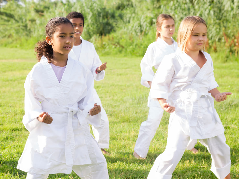 Group of children exercising in karate and traditional martial arts outdoor