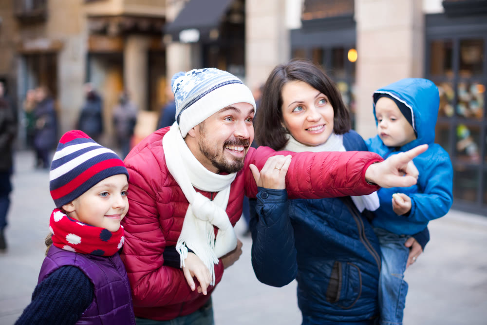 Man showing landmark for family at city