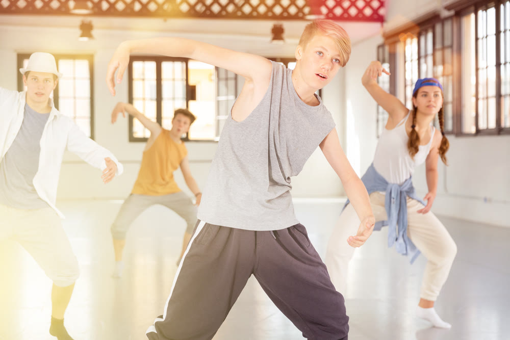 Boy training hip hop at group class