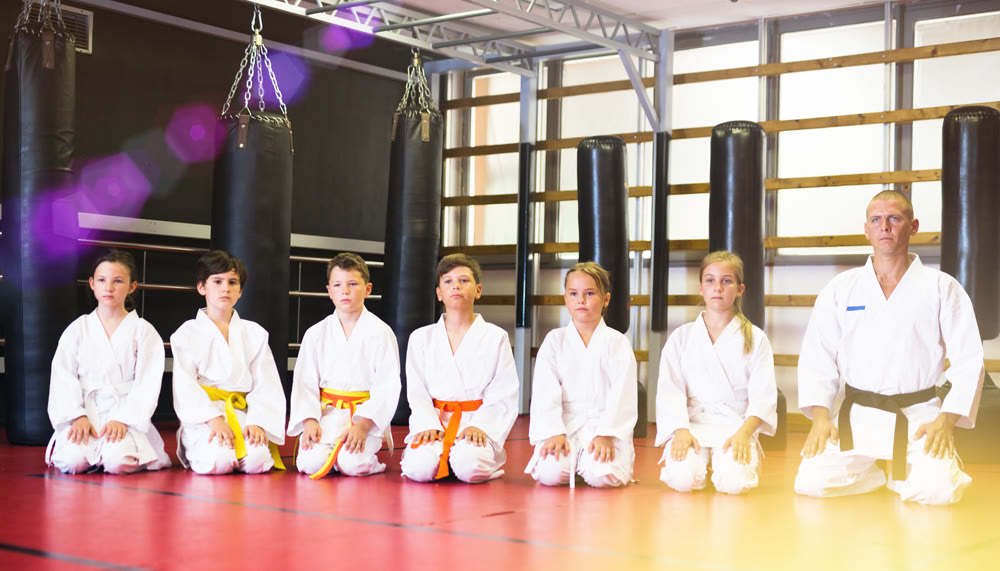 Group of karate kids and their trainer