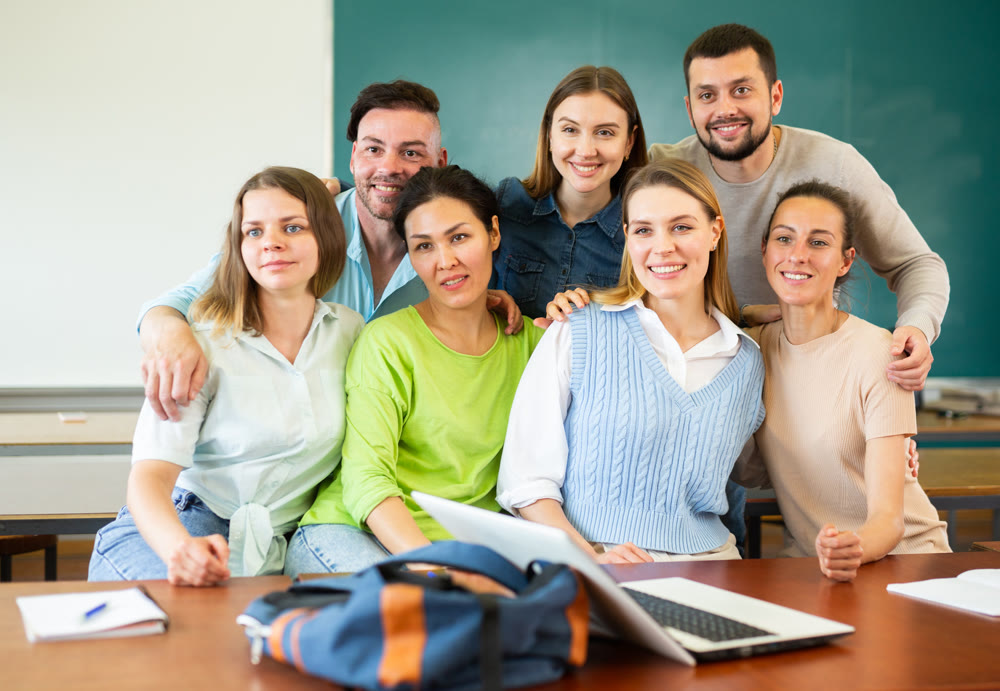Group portrait of group of university students in classroom
