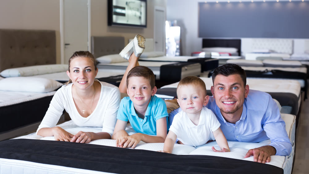 Family choosing mattress in store