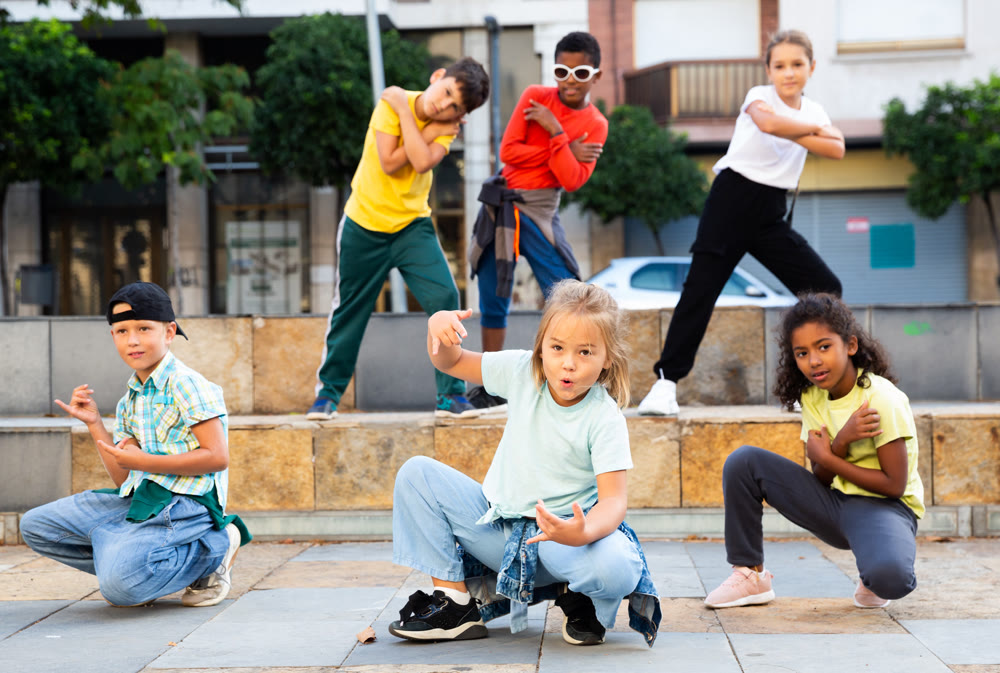 Modern tweenagers performing street dance choreography
