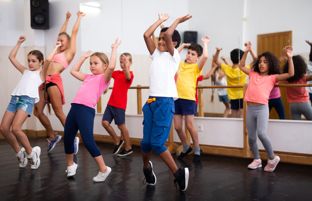 Boys and girls training in dance studio