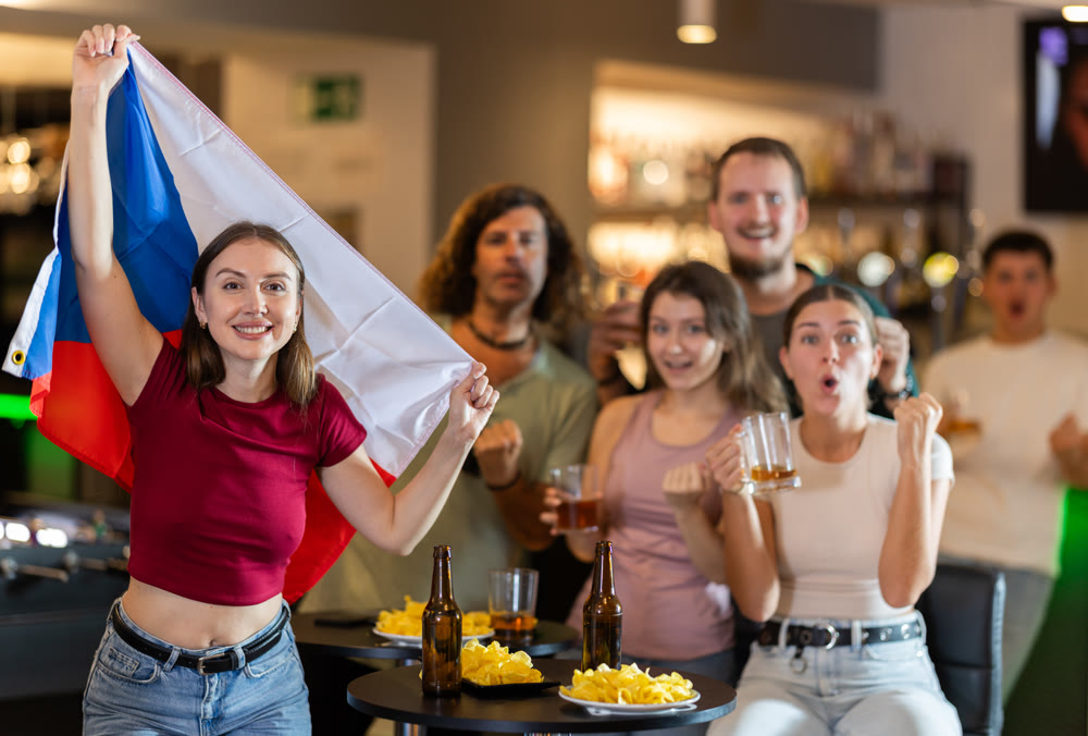 Group of fans in bar with Czech flag