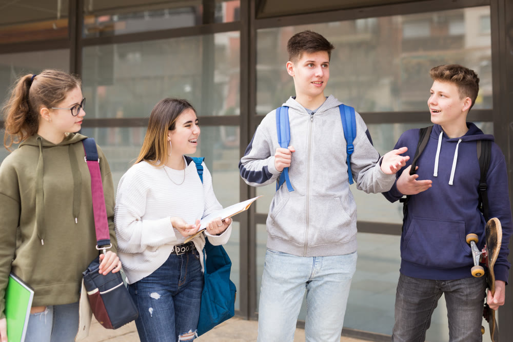 Teenage students talking outside after lessons