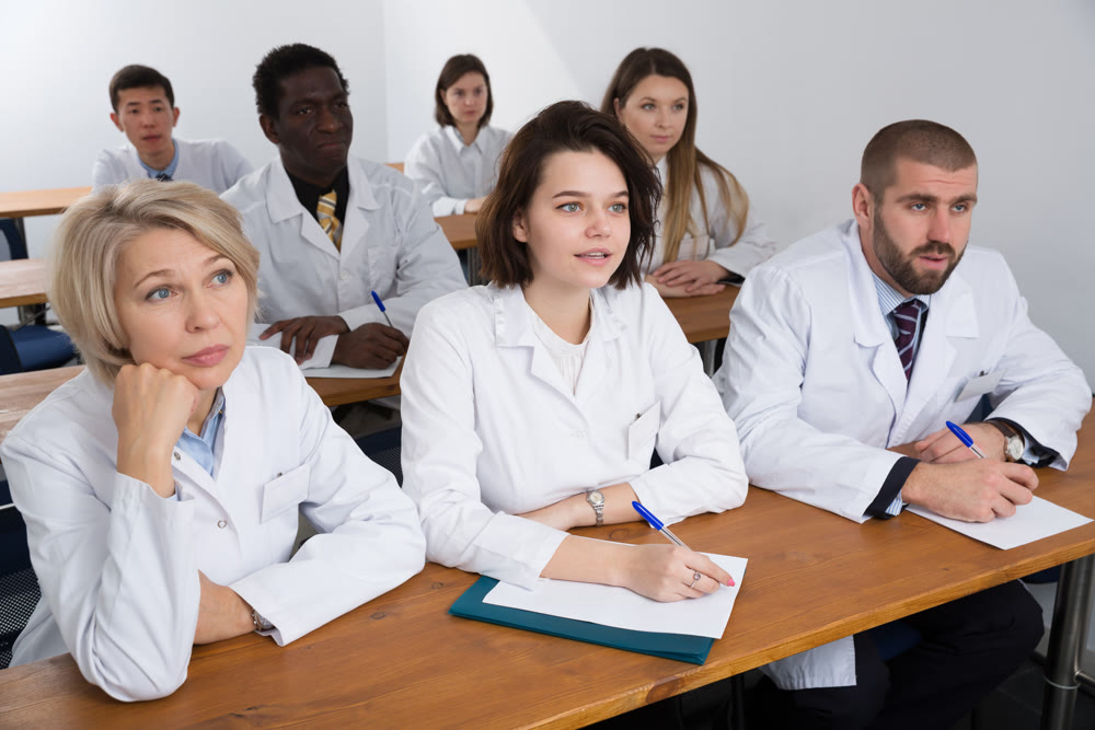 people attentively listening and making notes