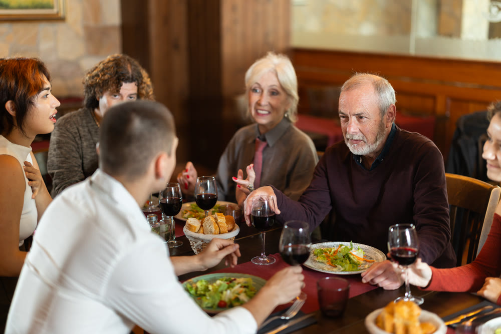 Family members enjoying warm conversation in restaurant