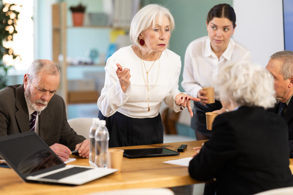 Senior female speaker share sad news or gives reprimands, criticizes employees