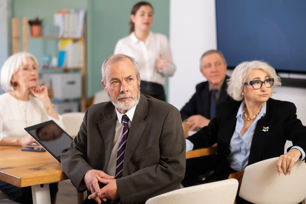 Businessman watching presentation while gathering in meeting room