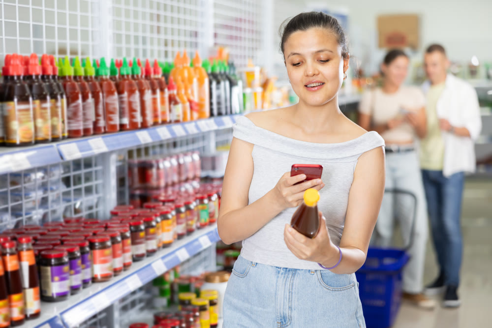 Woman looking for chili sauce using code on internet