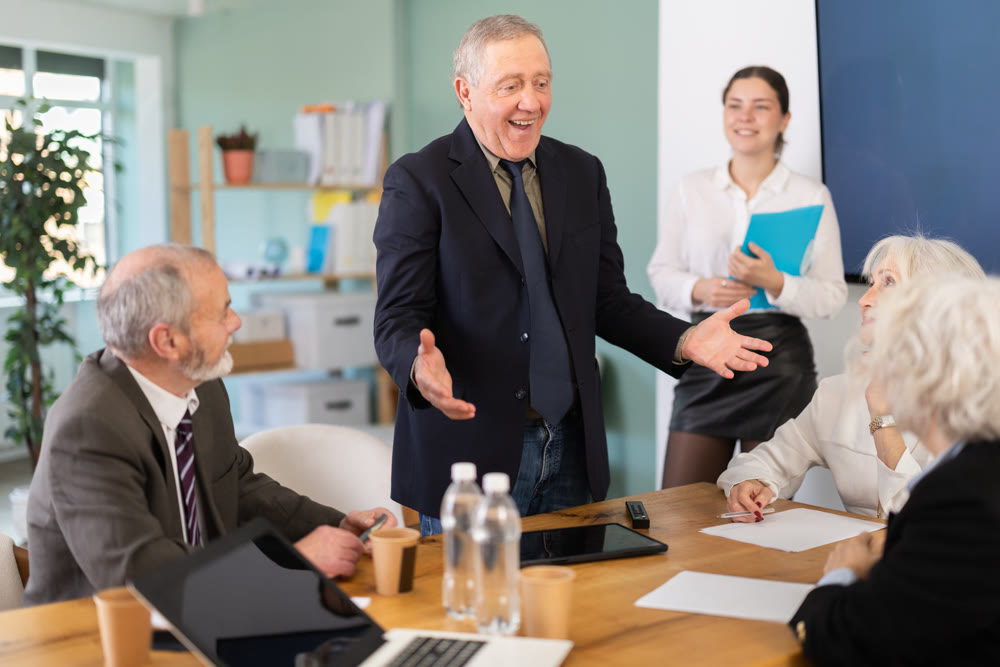 Businessman shares good news for her employees. Everyone is happy with the salary increase