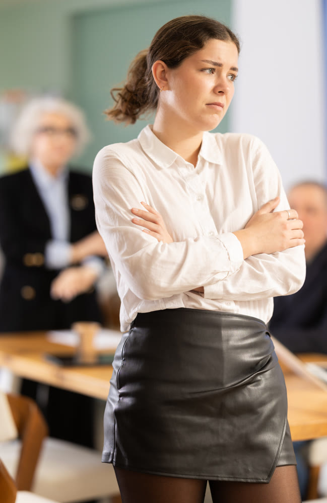 Elderly woman scolds young woman in office