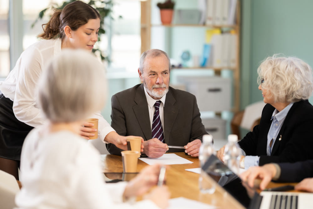 Male leader, trainer talking to group of people, brainstorming, discussing ideas in auditory