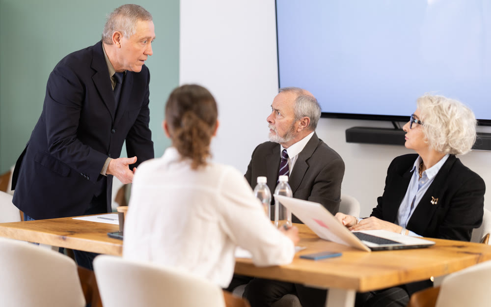 Male leader, trainer talking to group of people, brainstorming, discussing ideas in auditory
