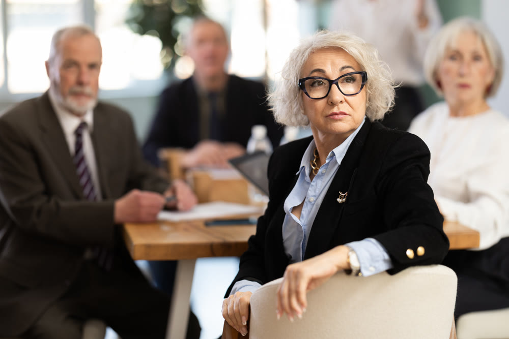 Girl with remote controller tell material, speaks to mature precursors of business group