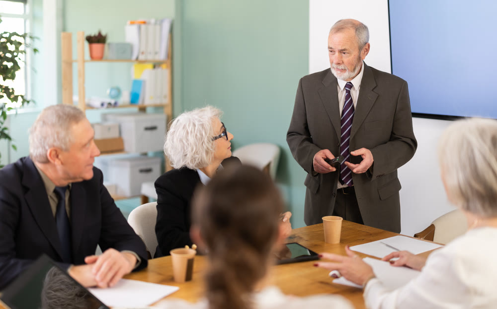 Elderly man presenting with remote control