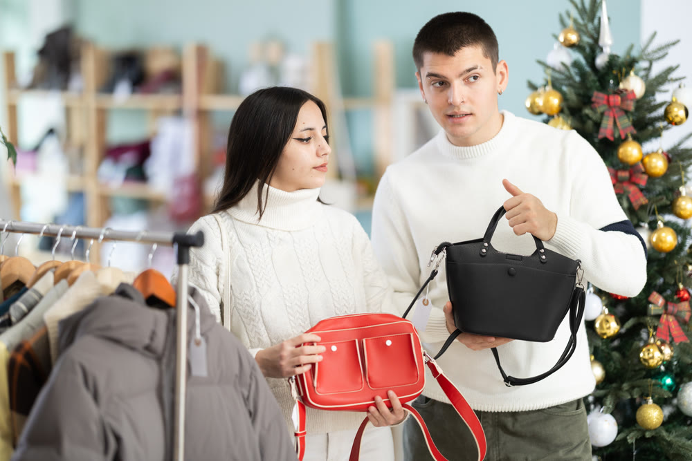 Couple customer choose handbag for girl, New Year atmosphere