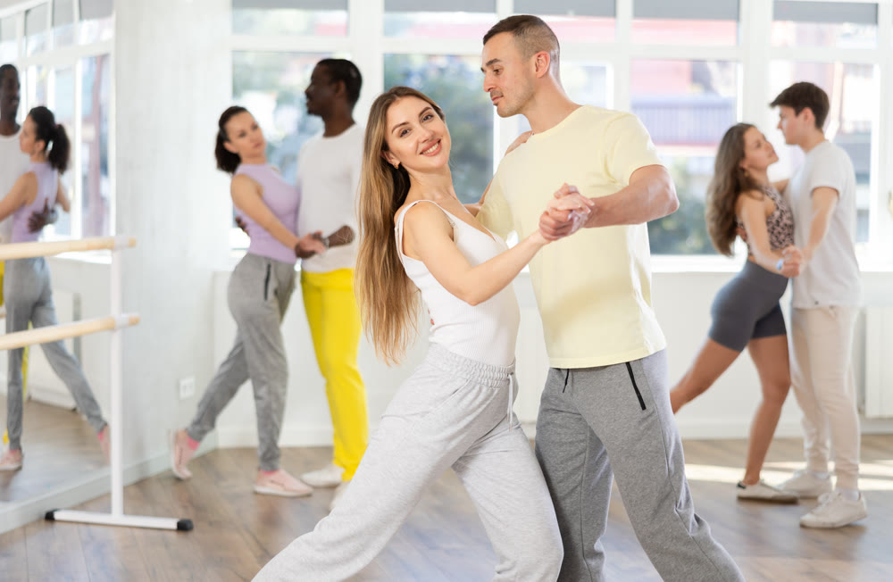 Young man and woman dancing latin dances
