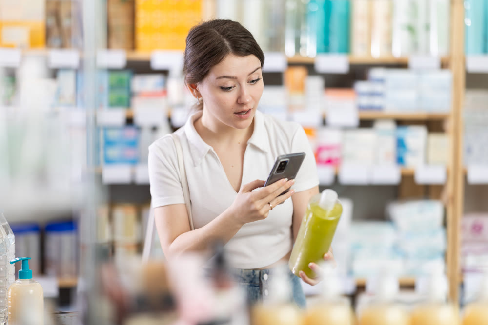 Woman scans for mobile shampoo in pharmacy