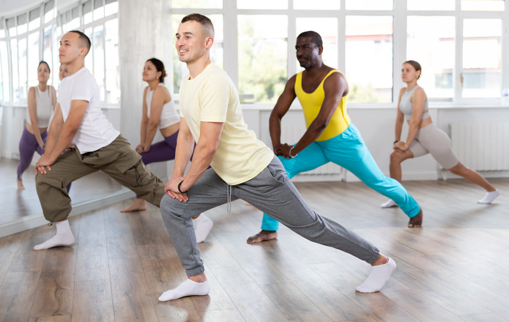 Group of people warming up before dance class