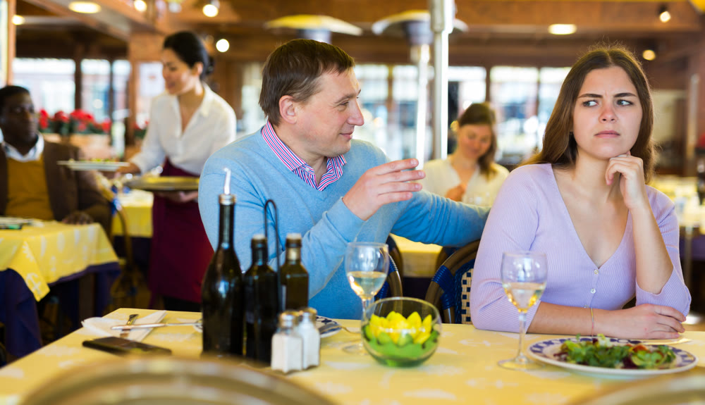 Quarreled visitors female and male at restaurant on celebrate