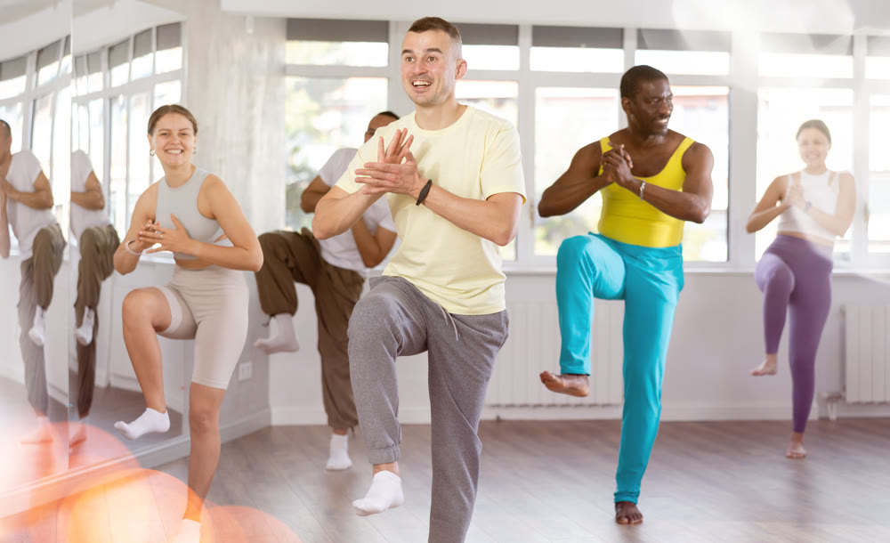 European guy with team of like-minded multinational people learn to elements of hip hop dance