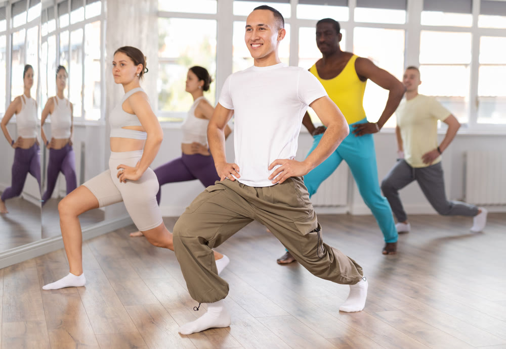 Group of people warming up before dance class