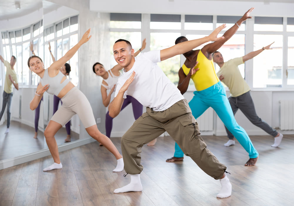European guy with team of like-minded multinational people learn to elements of hip hop dance