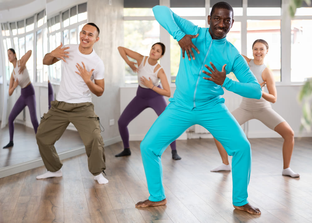 Middle-aged Afro-American man practicing active dance in training hall