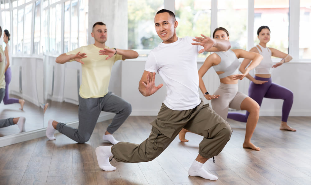 Young Asian man practicing aerobic dance in training hall