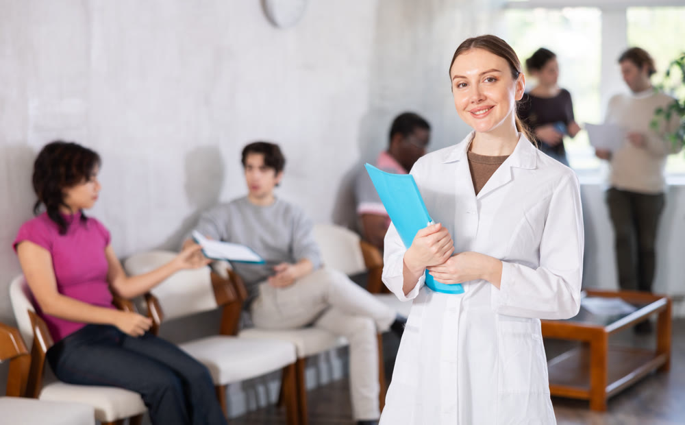 Female doctor in medical uniform posing in clinic reception