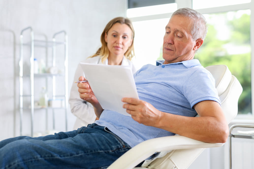 Adult woman doctor giving contract to patient for signing