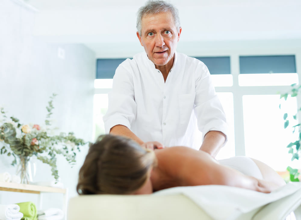 male masseur giving massage to female patient