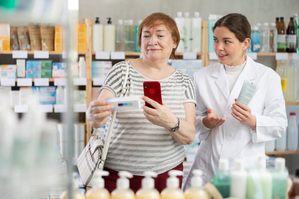 woman using phone and scanning barcode of antifungal ointment