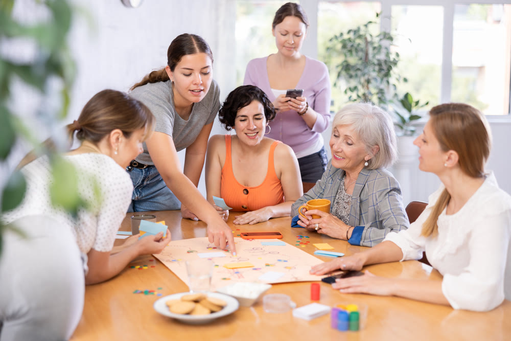 Friendly group of women playing entertaining board game