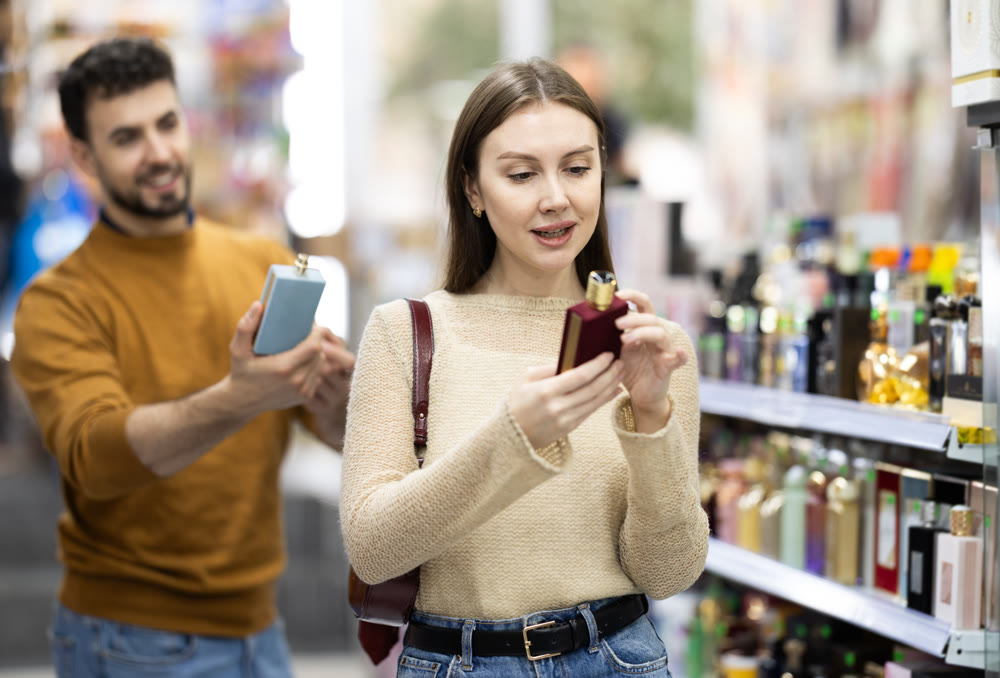 Couple spends time in store, looking for goods and select perfume
