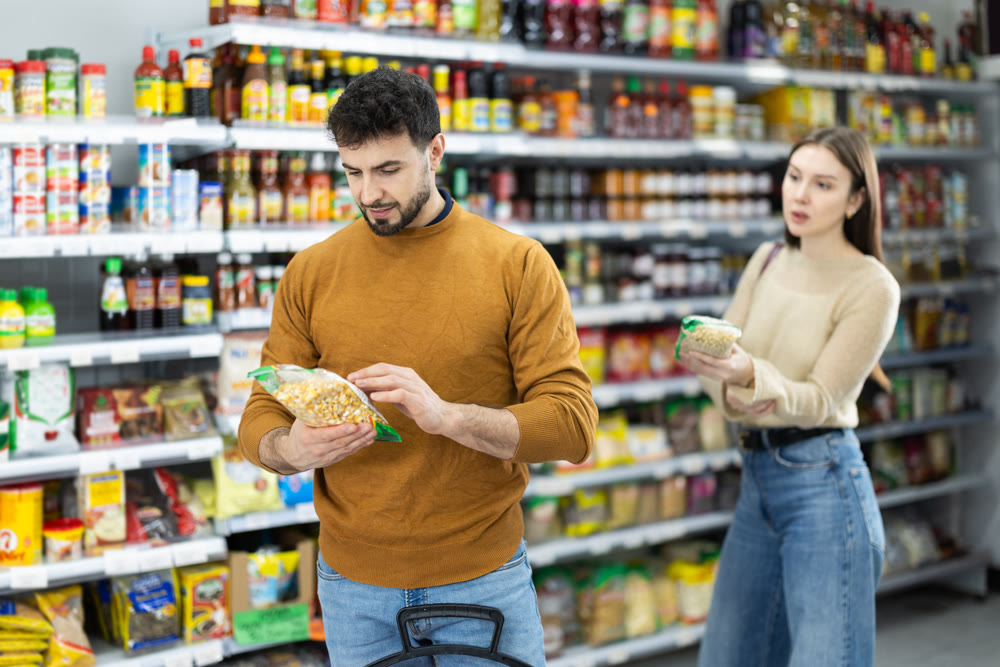 Young couple chooses beans in store
