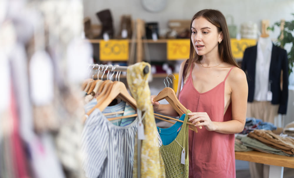Woman choosing a summer dress in a store