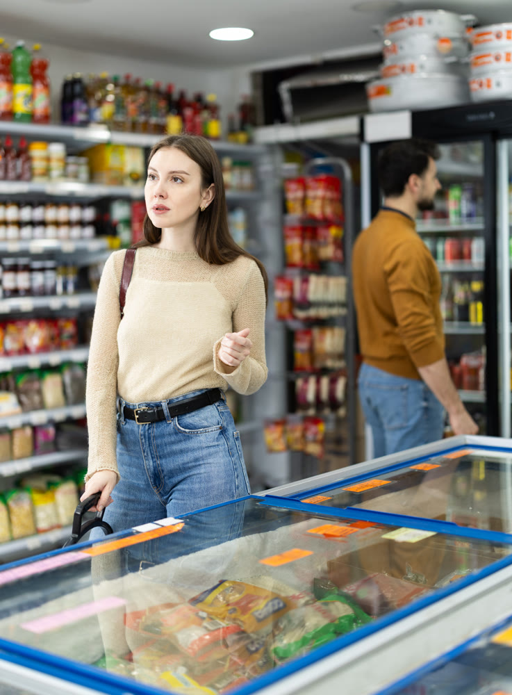 Female shopper are choosing something in food store