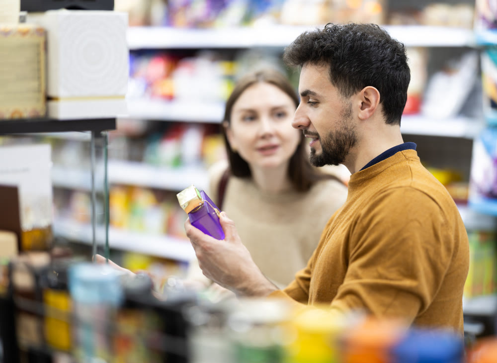 Couple spends time in store, looking for goods and select perfume