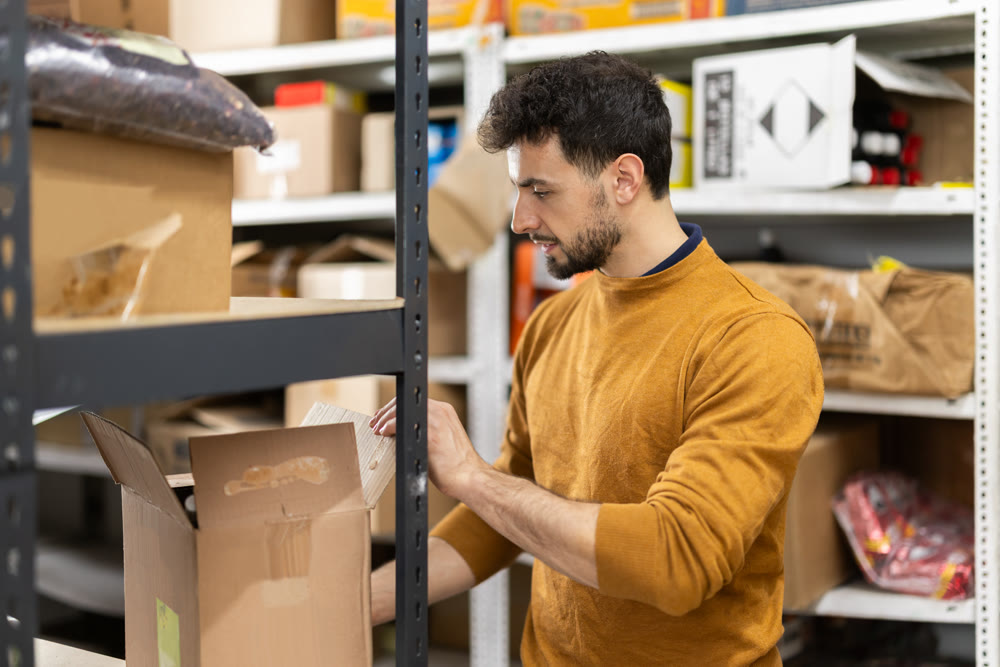 Positive worker loading box at warehouse store