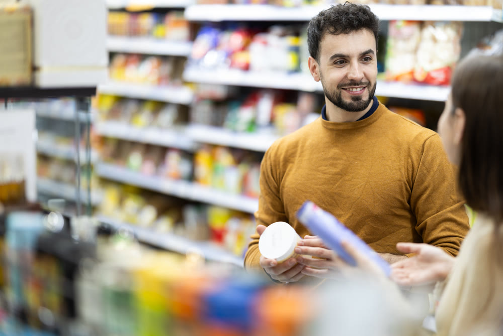 Couple spends time in store, looking for goods and select care product