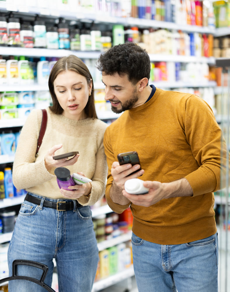 Couple get acquainted with good, scan QR code, take reading label using phone camera in shop