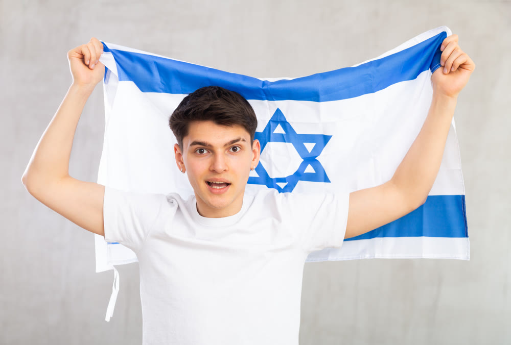 Guy holding the Israel flag in her hands