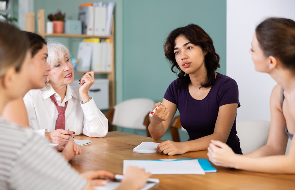 Female participate sit at circle, chatting, talking