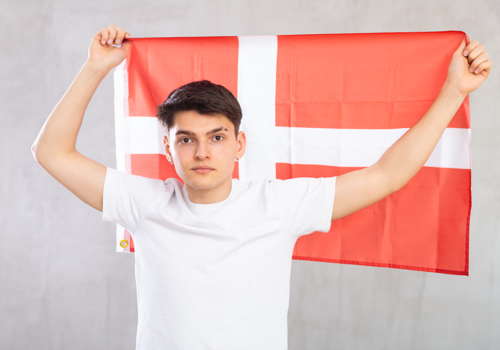 Guy holding the Danish flag in her hands