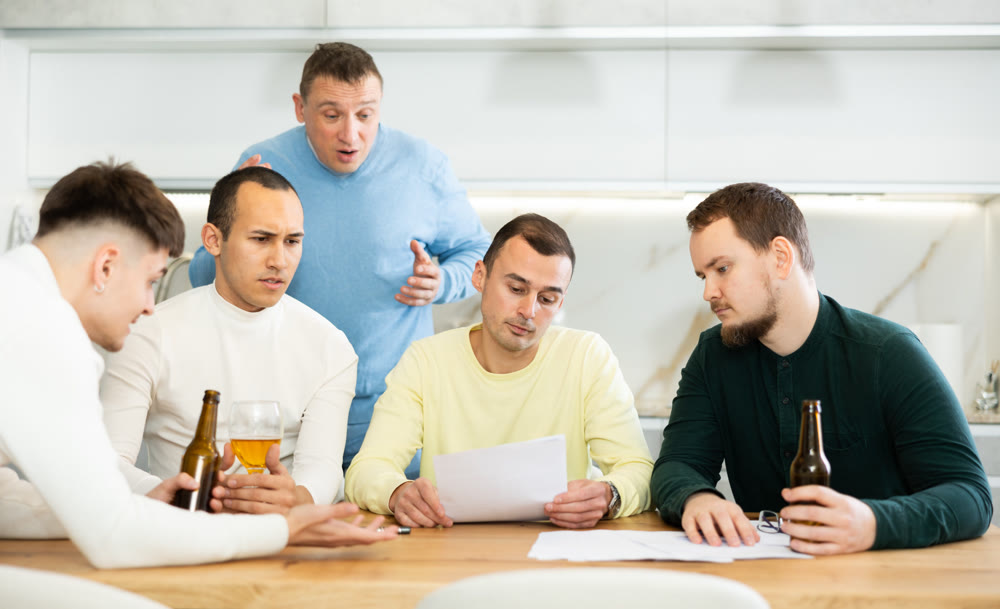 Friends comforting upset man receiving unpleasant news