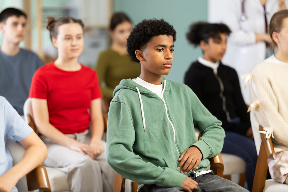 Afro American boy attentively watching presentation