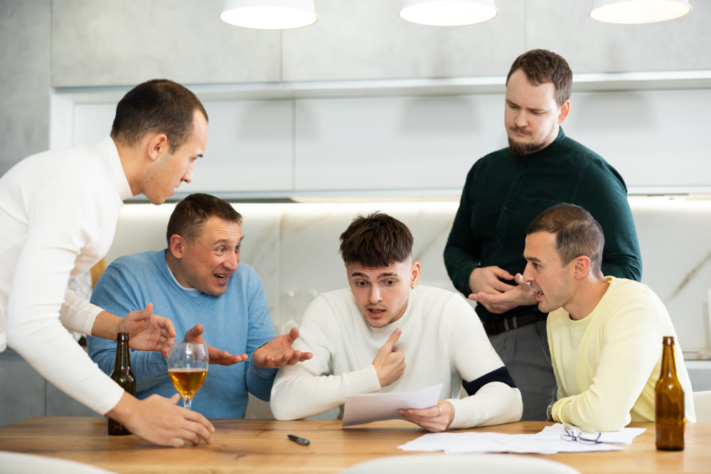 Friends consoling upset worried man reading unexpected medical results